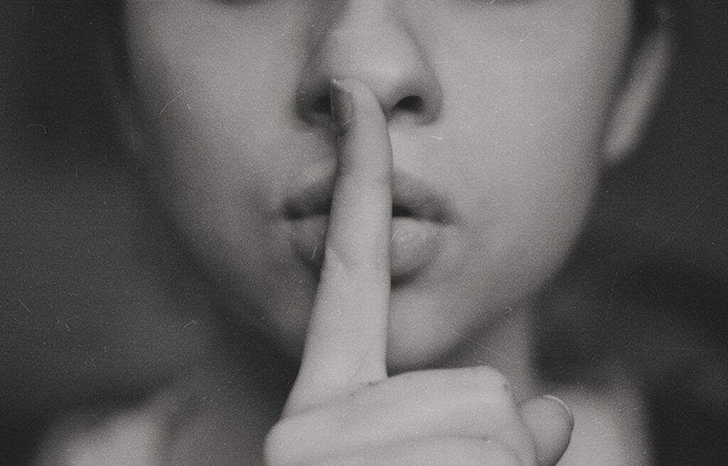 finger to mouth, silenced 